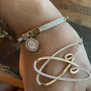 Michael Kors rose gold bracelet and earring set.